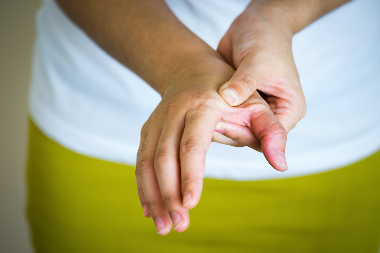 Closeup of Young Woman Suffering from Pain in Hand, People with